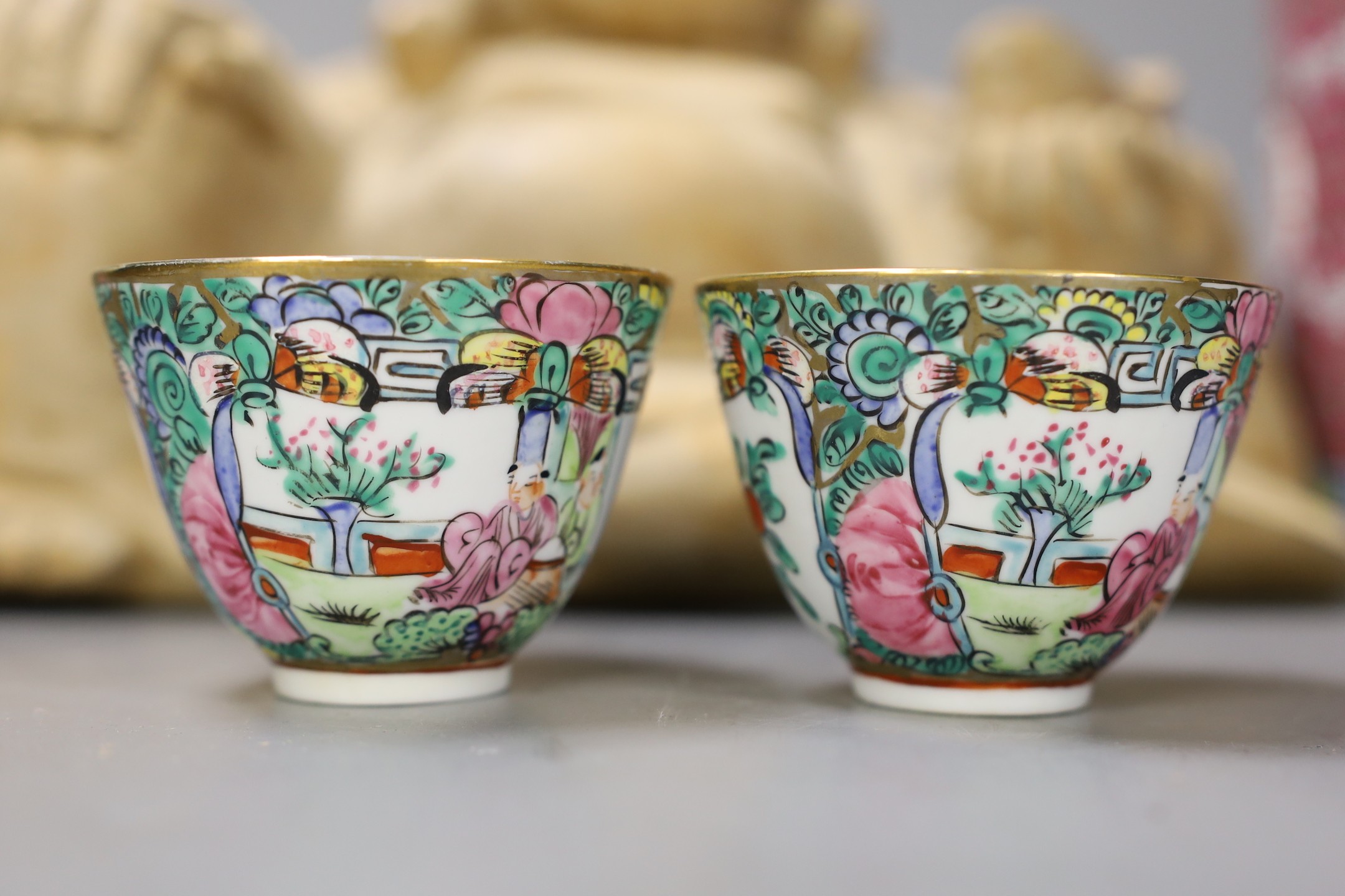 A Chinese wooden figure of Budai, two teapots in baskets and a tea caddy